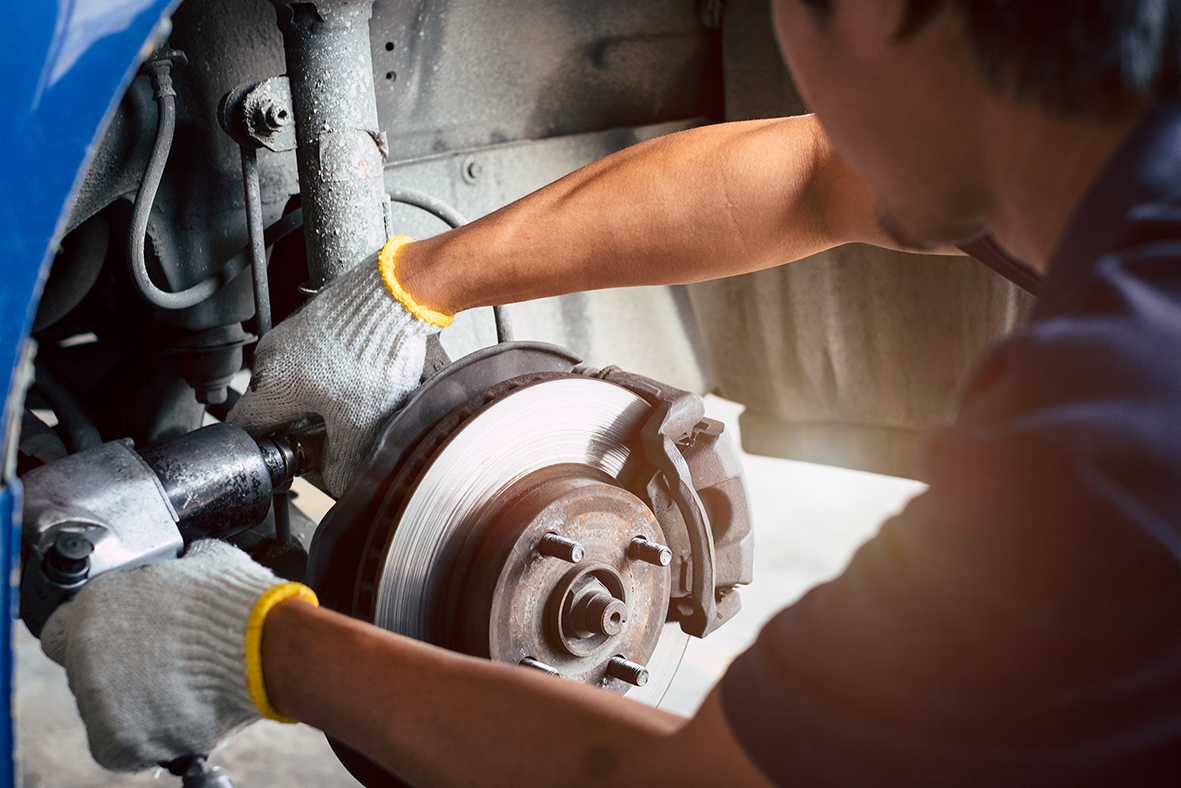 Selective focus disc Shock absorber on car, in process of new Shock replacement, Car repairing in garage